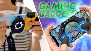 Mobile gaming gadgets including cooling fans, controllers, and touch-sensitive triggers used to enhance smartphone gaming experience.**
